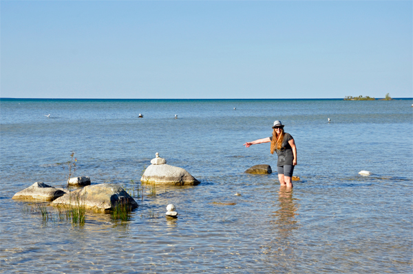 Karen Duquette walks in the water at Grand Traverse Bay